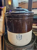 Crock with lid in full view showing two-tone glaze