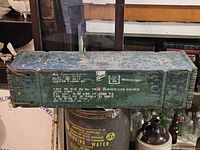 Full view of long wooden ammunition crate showing size and paint