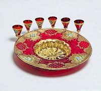 Top view of red and gold Murano glass bowl with six matching goblets