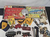 Group shot of cast iron toys, flashlights, Scout items, plaques, Erector and Build-A-Home sets