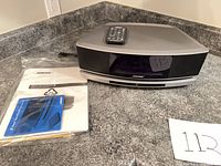 Front view of Bose Wave SoundTouch with remote and manuals