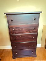 Front view showing five drawers and knobs