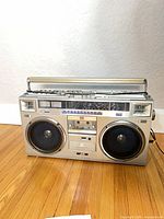 Front view of JVC RC-M70C boombox showing speakers, cassette deck and controls