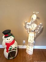 Angel and snowman lit, power cords visible