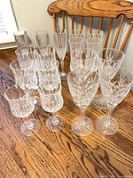 All 17 cut-crystal stemware pieces on wooden table
