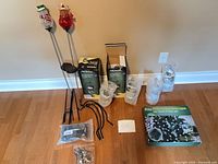 Entire lot showing boxed and unboxed solar lights, hooks and hardware