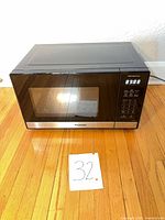 Front view of Panasonic microwave showing control panel and display