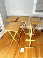 Four folding tables opened beside storage stand