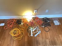 All cords, power bars, trouble light grouped on floor