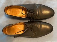 Top view of pair of black leather oxford shoes showing uppers and laces