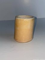 Side view of cup showing glaze and crack