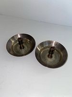two silver-tone saucer candle holders