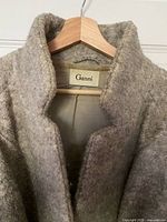 Brand label and collar of Ganni coat