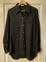 Full view of front of grey flannel shirt hanging