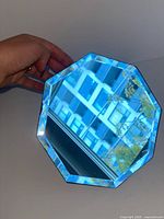 Front view showing octagonal mirror surface and beveled blue-tinged edge