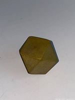 Oblique view of the brass faceted paperweight