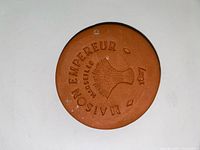 Front of terracotta hydrostone showing embossed Maison Empereur Marseille 1847 and wheat motif