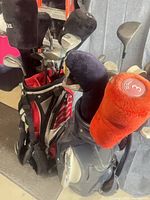 Two golf club sets in bag with headcovers