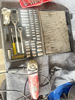 Overall view of socket set in black case and Skil grinder