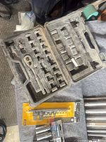 Open socket set case showing ratchet and sockets; packaged Titan bit set visible