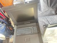 Belkin 15" LCD rack console open showing screen, keyboard, touchpad