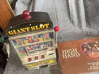Front view of slot machine and partial board game box