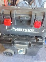 Stacked Husky toolbox atop DeWalt rolling chest, front view
