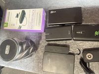 All items group shot showing boxed Retrak battery pack, six power banks, iHome speaker