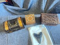 Overview of all three boxes and tooth on grey surface