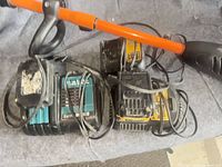 Makita and DeWalt chargers with cords alongside shaft