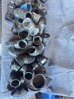 Top view of pile of ABS fittings showing variety of elbows and couplers