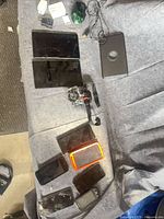 Overview of lot: two Samsung tablets, wired gaming mouse, action camera, six smartphones, power adapters