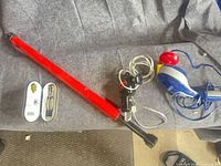 All items on grey fabric: pull-up bar, both massagers, dart set