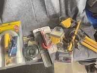 All items laid out showing sanding kit, power hub, bike hanger, screwdriver set, work light