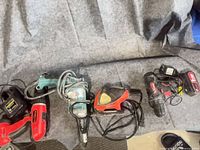 Overview of all four power tools lined up on blanket