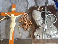 Wood crucifix, rosary, Pope John Paul II plaque visible