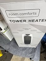 Boxed Room Comforts tower heater showing branding and features