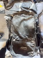 Front view showing Serratus logo, mesh pocket, grey straps