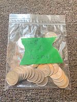 Bag containing stacked Canadian RCMP quarters