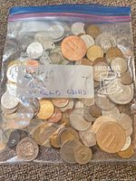 Front view of bag displaying mixed world coins