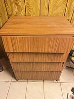 Front view of dresser showing four drawers and veneer finish