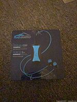 Front of box showing StreamDM player and Surge S+ headphones