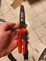 Pliers in hand, showing front jaw and handles