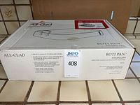 Factory sealed All-Clad Roti Pan box showing model and details