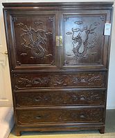 Full frontal view showing entire cabinet, dragon carvings, drawers, doors, brass hardware