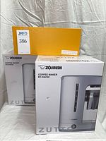 Front view of two boxed Zojirushi EC-DAC50 coffee makers
