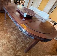 Full view of oval table with leaves installed and pads stacked on top