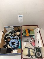Overview of both boxes showing dictionary, cameras, cables and accessories