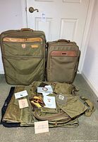 Full lot showing two roller suitcases and accessories spread in front