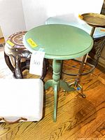Green round side table, rosewood barrel stool, brass pedestal, cream footstool visible